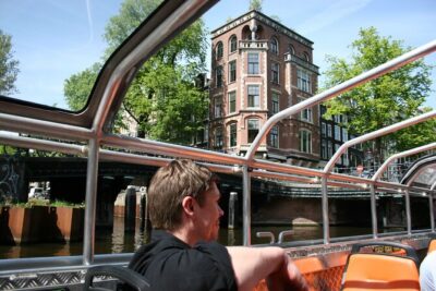 Amsterdam 1h Canal Cruise by Semi-Open Boat with Audio Guide - What Regular Departures Mean for Your Amsterdam Day Plan