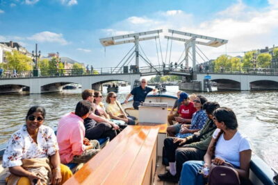 Amsterdam: 75 minute Open Boat Canal Cruise with Live Guide - Meeting at the Blue Boat Company dock (Stadhouderskade 501) without stress