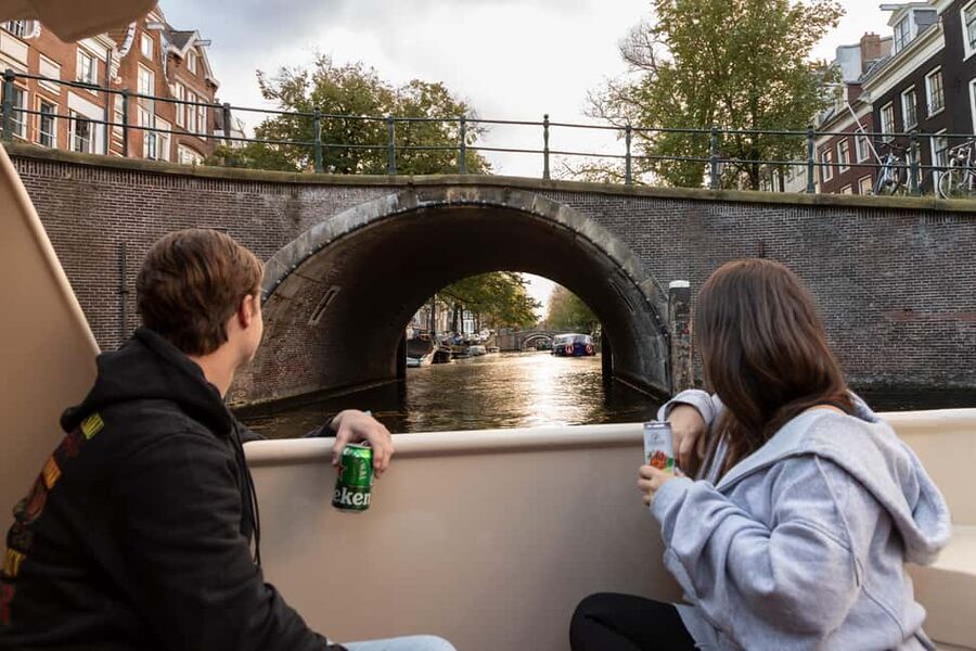 Amsterdam: Canal Cruise with Live Commentary & Audio Guide - Amstel and Binnenstad: Bridges, Church Views, and Houseboat Life
