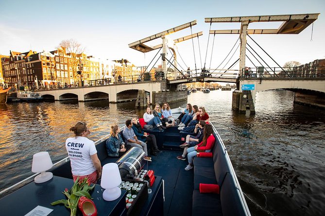 Amsterdam Canal Cruise With Live Guide and Unlimited Drinks - Markets and museums from the canal: cheese, canals, and science vibes