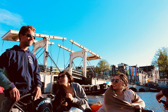 Amsterdam Canal Tour by Open Boat – 90 min Small Group Experience - Cruising near De Wallen: dancing houses, Zuiderkerk, and the old alleys