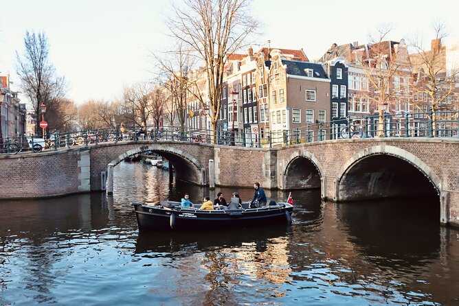 Amsterdam Canal Tour by Open Boat – 90 min Small Group Experience - Comfort on an open boat: blankets, wind, and rainy-day cover
