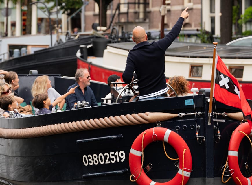 Amsterdam: Guided Open Boat Canal Cruise Including Drink - The guide and skipper: the human part that turns sights into stories