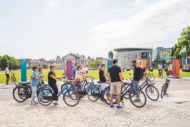 Amsterdam Small-Group Bike Tour With Optional Canal Cruise - Getting Oriented Fast at the Start Near Nieuwezijds Voorburgwal