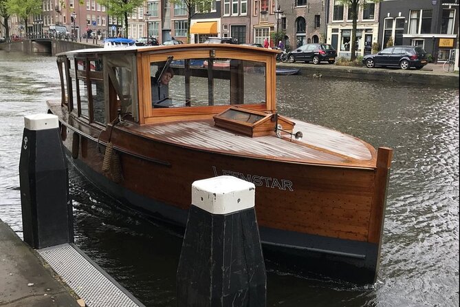 Amsterdam small-group canal cruise in 1920s saloon boat - On-Board Comfort: Heater, Blankets, Covered Seating, and Drinks