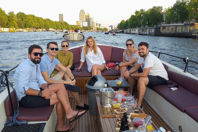 Guided Amsterdam Canal Cruise – Snacks & Drinks on board(1 Hour) - A small-boat Amsterdam canal cruise through the oldest canals