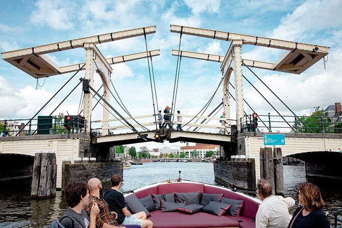 Guided Amsterdam Canal Cruise – Snacks & Drinks on board(1 Hour) - Seven aligned arch bridges, the wooden drawbridge kiss legend, and crooked houses